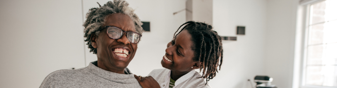 Older man laughing with woman smiling at him